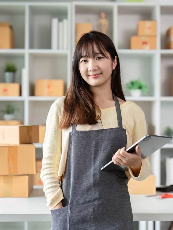 portrait-of-a-young-woman-entrepreneur-in-her-home-office-with-shipping-boxes-and-digital-tablet.jpg